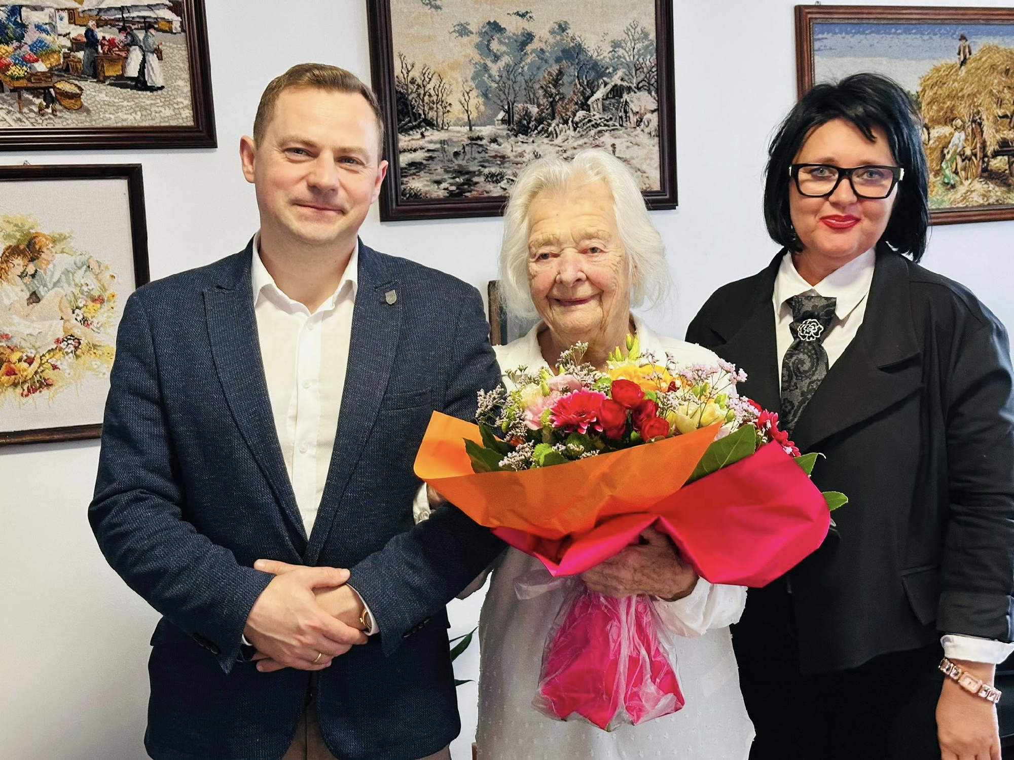 3 osoby jedna osoba trzymająca kwiaty 